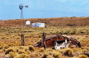 RED MESA, ARIZONA, NOVEMBER 14, 2003 - An abandoned Navajo dwelling, most probably a sweat lodge, is seen near the Red Mesa school complex.  In the background is a windmill, which is the primary source of water for Navajo livestock.  (Betty E. Cauler/TMC)  for Adventures story.