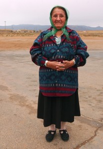RED MESA, ARIZONA, NOVEMBER 14, 2003 - A Navajo grandmother, who could not speak English, poses for a picture outside the Red Mesa Trading Post in exchange for a cup of coffee.  Many Navajo elders speak only in their native language, and their children and grandchildren act as interpreters.  It is customary to always ask first before taking a photograph of the Navajo people, or Dine as they call themselves, and a gratuity is expected.  Long exploited by the Anglo culture, the Dine (which literally means "The People") may seem standoffish at first, but laughter is one of the best and most universal ways to gain the trust of this shy and peaceful people.  Visitors to the reservation are asked to respect the privacy and property of the inhabitants.  (Betty E. Cauler/TMC)